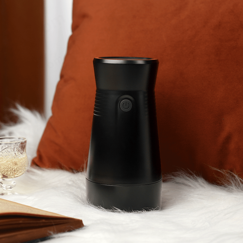 Black male masturbator on a white surface with a brown pillow in the background