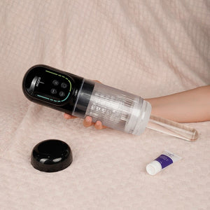 Person holding a black and clear electronic device on a beige surface with a tube of cream nearby.