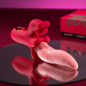 Red and pink silicone product on a reflective surface with a blurred background