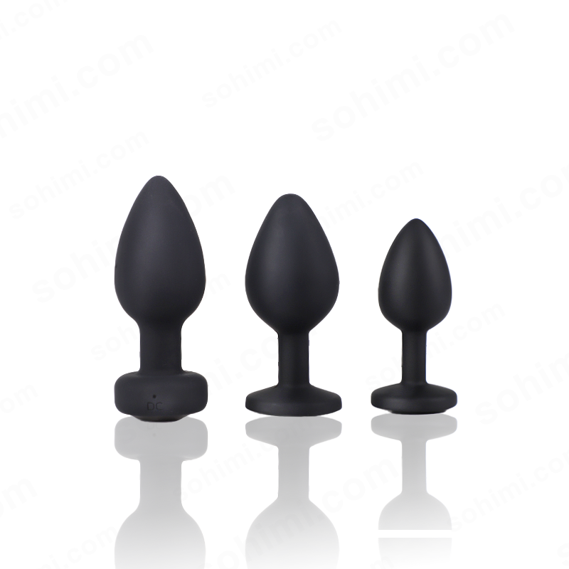 Three black silicone butt plugs of different sizes on a white background