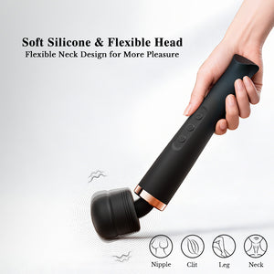 Black handheld device with soft silicone and flexible head, held by a hand on a light gray background.