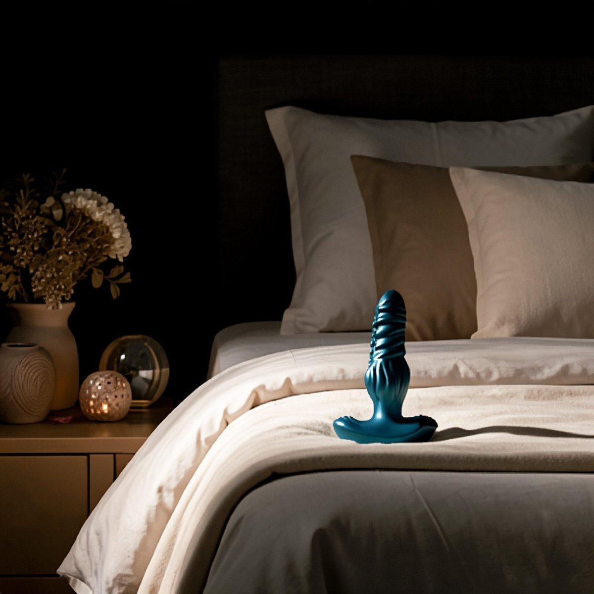 Blue object on a bed with a dark background