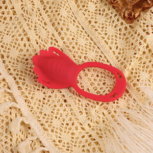 Red silicone ring on a textured beige surface